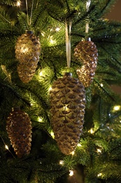 Christmas tree decorated with holiday baubles and fairy lights, closeup