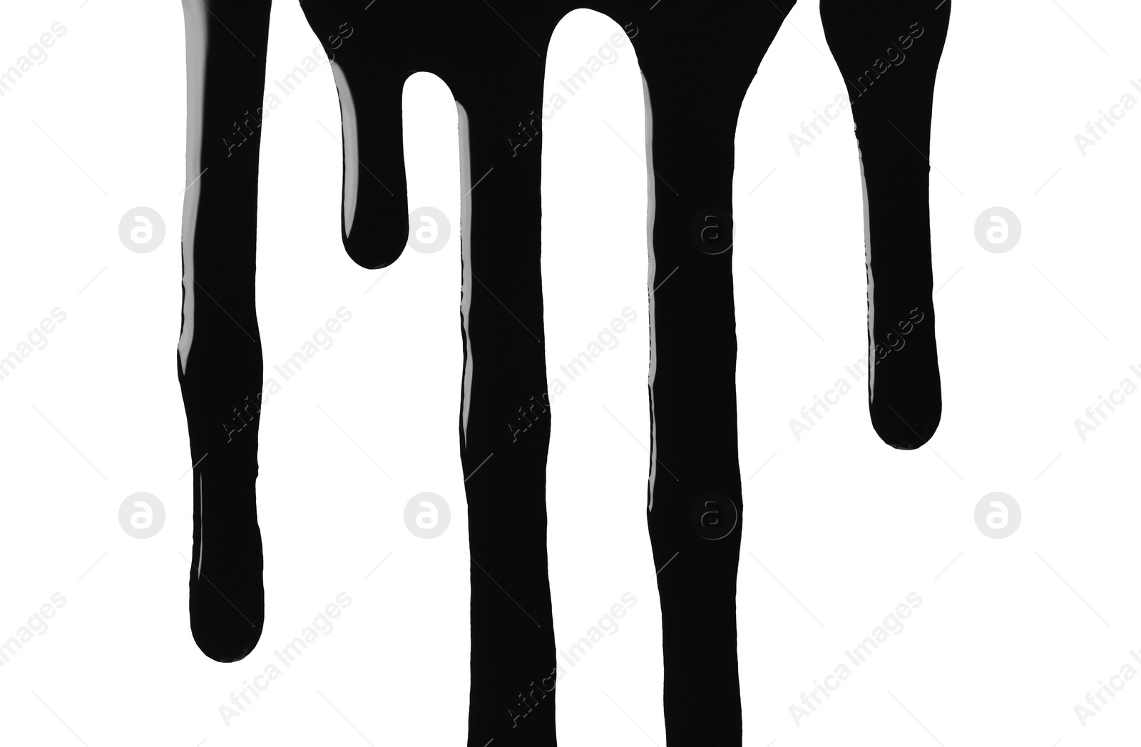 Photo of Black glossy oil flowing on white background