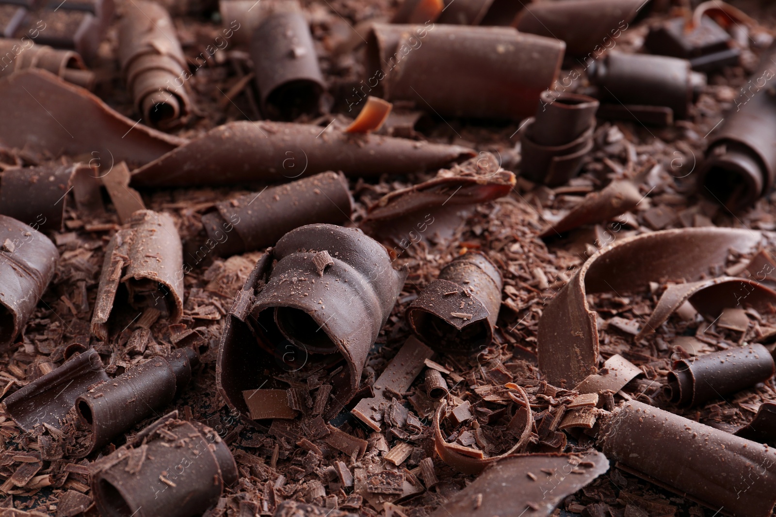 Photo of Yummy chocolate curls for decor as background, closeup