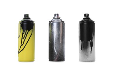 Photo of Used cans of spray paints on white background. Graffiti supplies