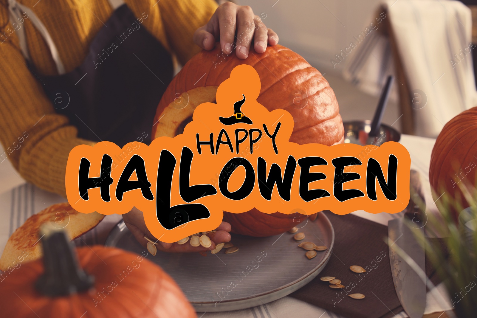 Image of Happy Halloween.Woman making pumpkin jack o'lantern at table, closeup
