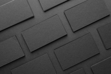 Photo of Blank business cards on black background, flat lay. Mockup for design