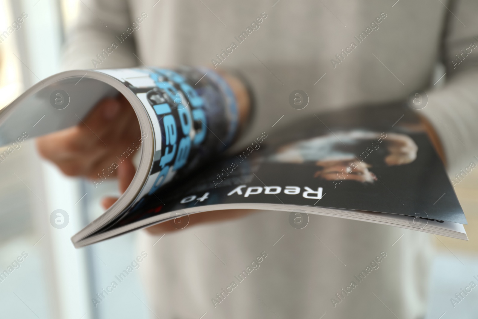 Photo of Closeup view of man reading modern magazine