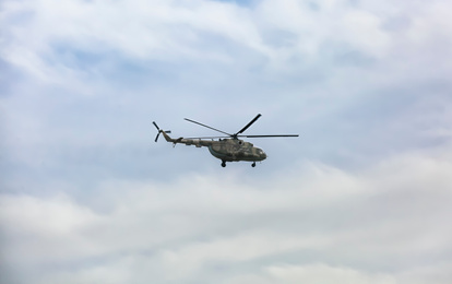 Photo of Distant view of military helicopter flying in sky