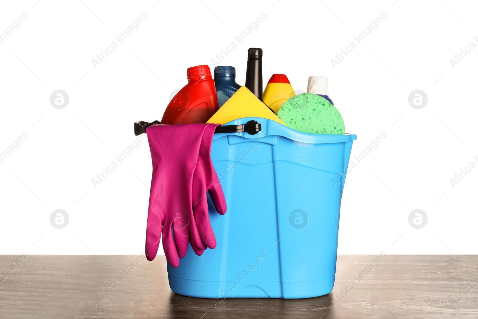 Photo of Light blue bucket and many different car wash products on black wooden table against white background