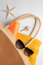 Photo of Flat lay composition with sunscreen and beach accessories on white background