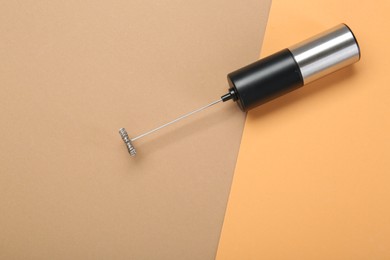 Photo of Milk frother wand on color background, top view. Space for text