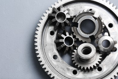 Photo of Different stainless steel gears on light grey background, top view