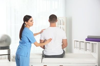 Photo of Doctor working with patient in hospital. Rehabilitation massage