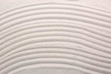 White sand with pattern as background, top view. Concept of zen and harmony