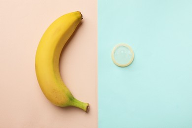 Photo of Banana and condom on color background, flat lay. Safe sex concept