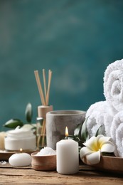 Beautiful spa composition with plumeria flower on wooden table. Space for text