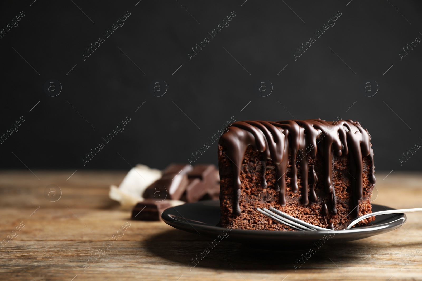 Photo of Tasty chocolate cake served on wooden table