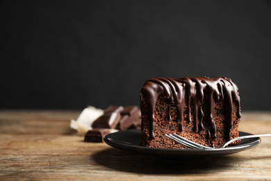 Tasty chocolate cake served on wooden table