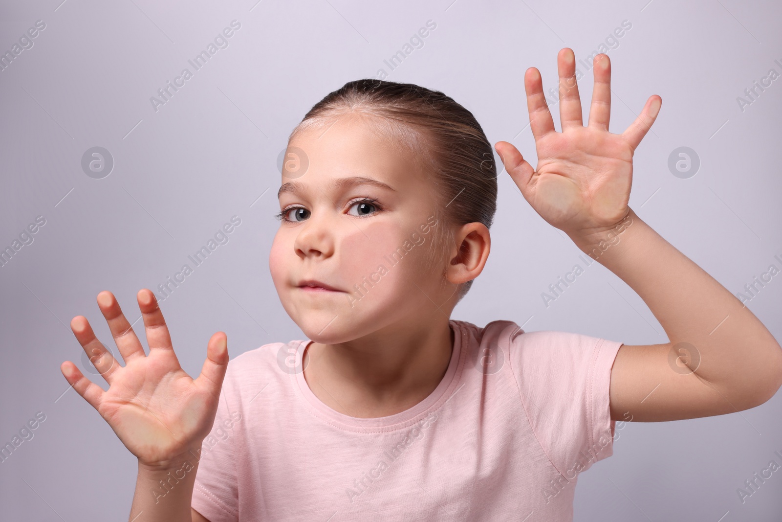 Photo of Cute little girl stuck to transparent screen