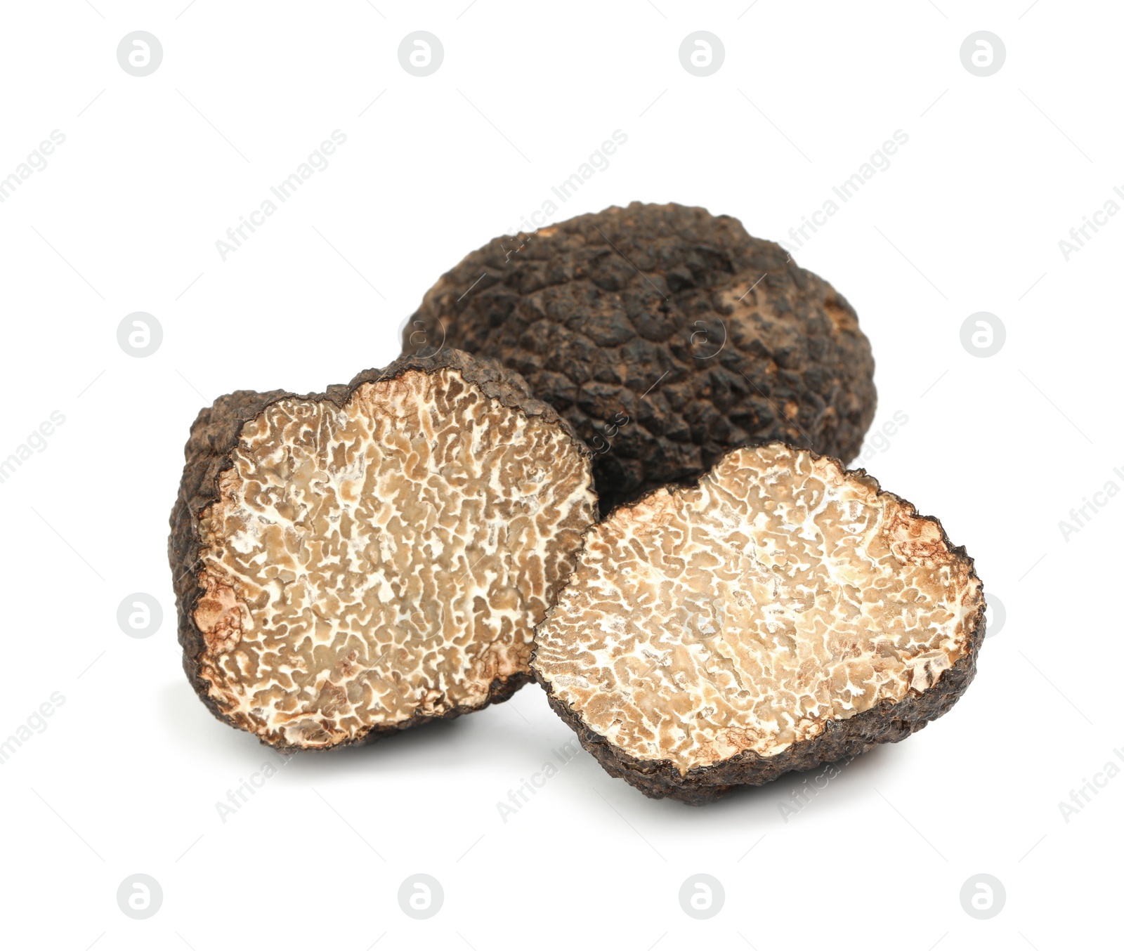 Photo of Cut and whole black truffles isolated on white