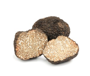 Photo of Cut and whole black truffles isolated on white