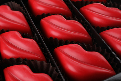 Delicious lip shaped chocolate candies in box, closeup