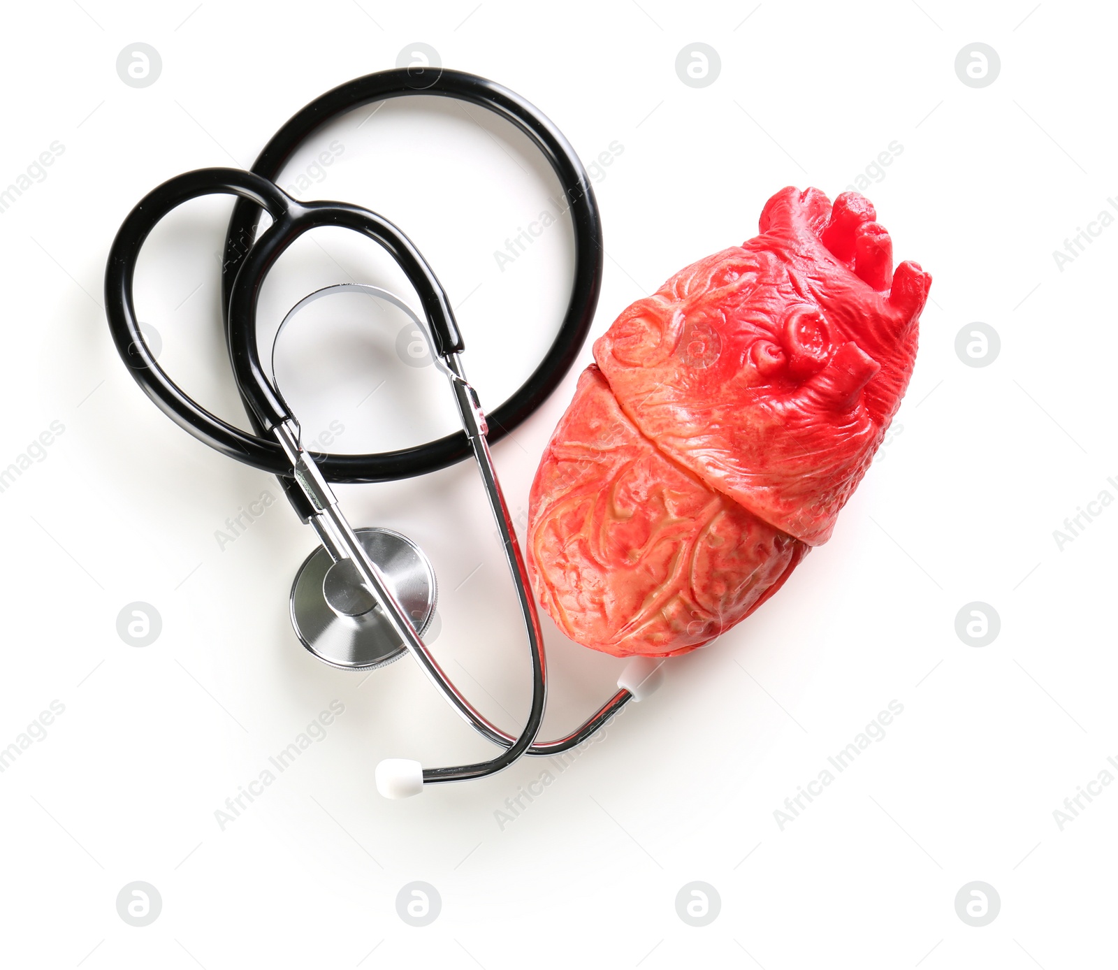 Photo of Stethoscope and model of heart on light background. Heart attack concept