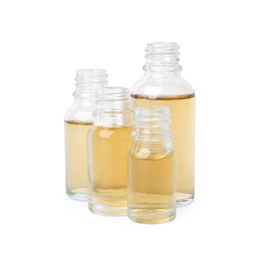 Photo of Glass bottles of essential oils on white background