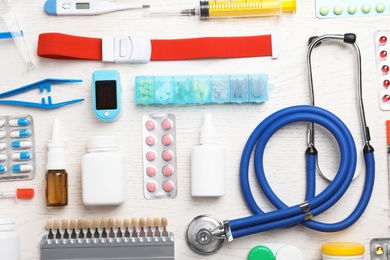 Flat lay composition with medical objects on white wooden background