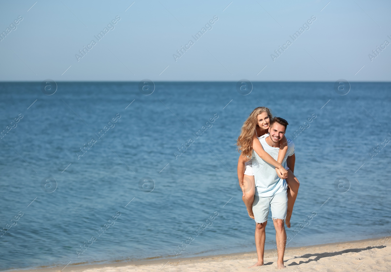 Photo of Happy young couple at beach on sunny day