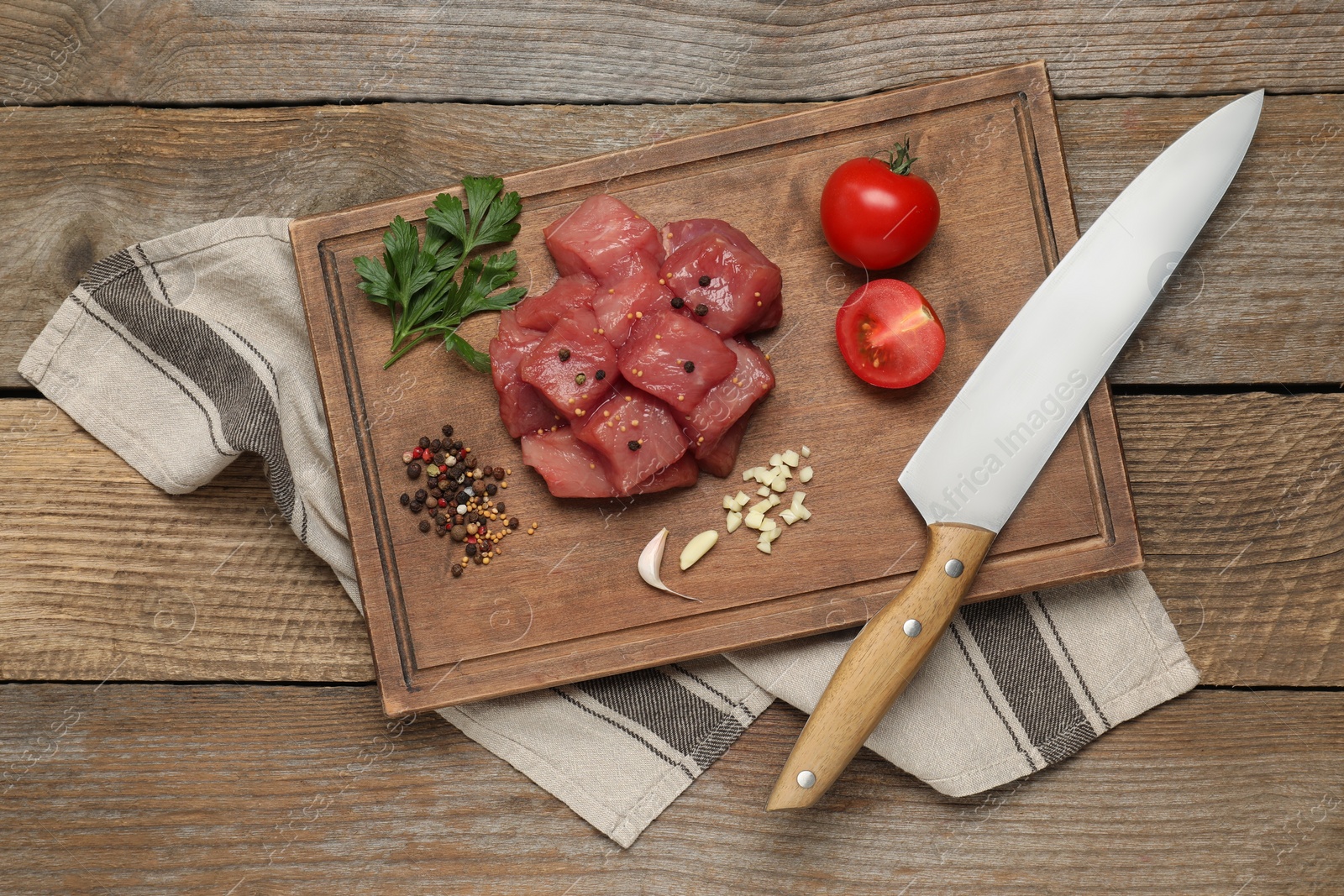 Photo of Raw beef meat and different ingredients for cooking delicious goulash on wooden table, flat lay