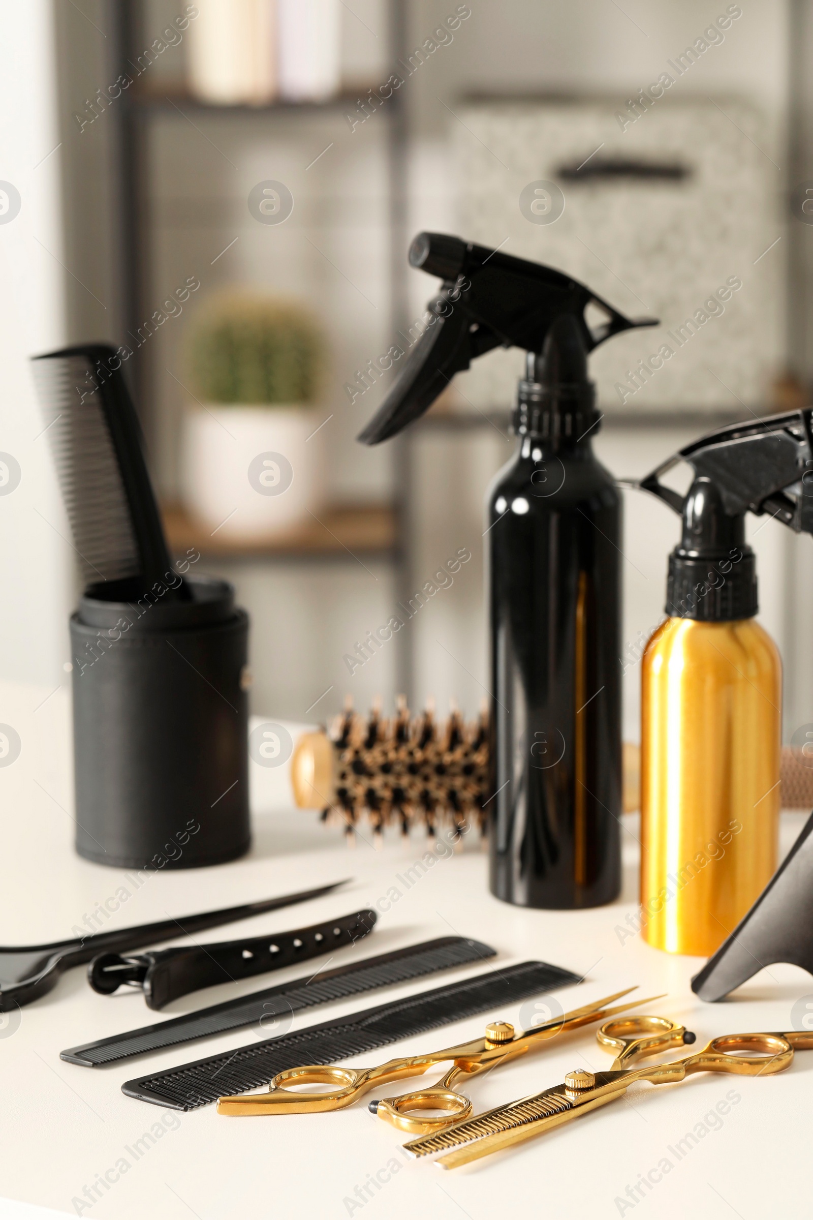 Photo of Hairdresser tools. Different scissors and combs on white table in salon