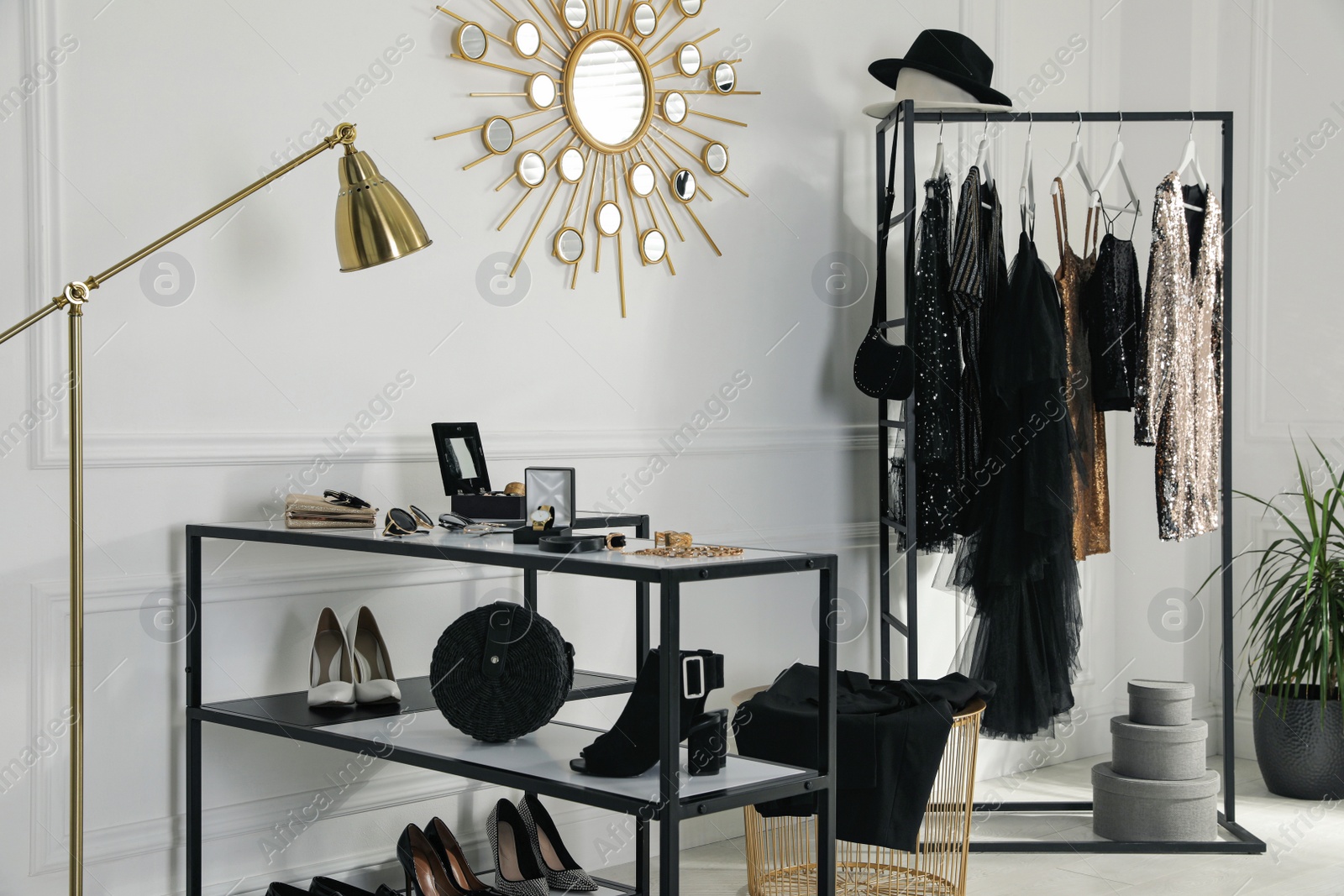 Photo of Stylish dressing room interior with trendy clothes and luxury accessories