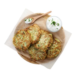 Photo of Delicious zucchini fritters with sour cream on white background, top view