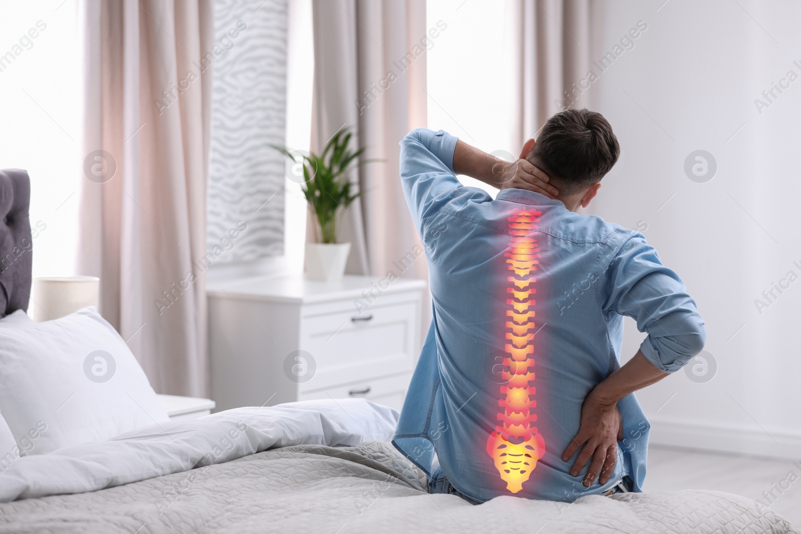 Image of Man suffering from pain in back at home