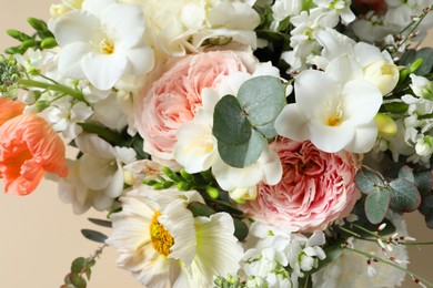 Photo of Bouquet of beautiful flowers on beige background, closeup