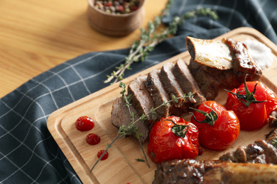 Delicious roasted ribs with served on wooden table, closeup