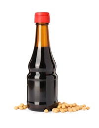 Photo of Bottle of soy sauce and soybeans isolated on white