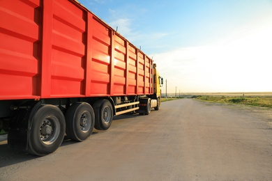 Photo of Modern truck on country road. Space for text