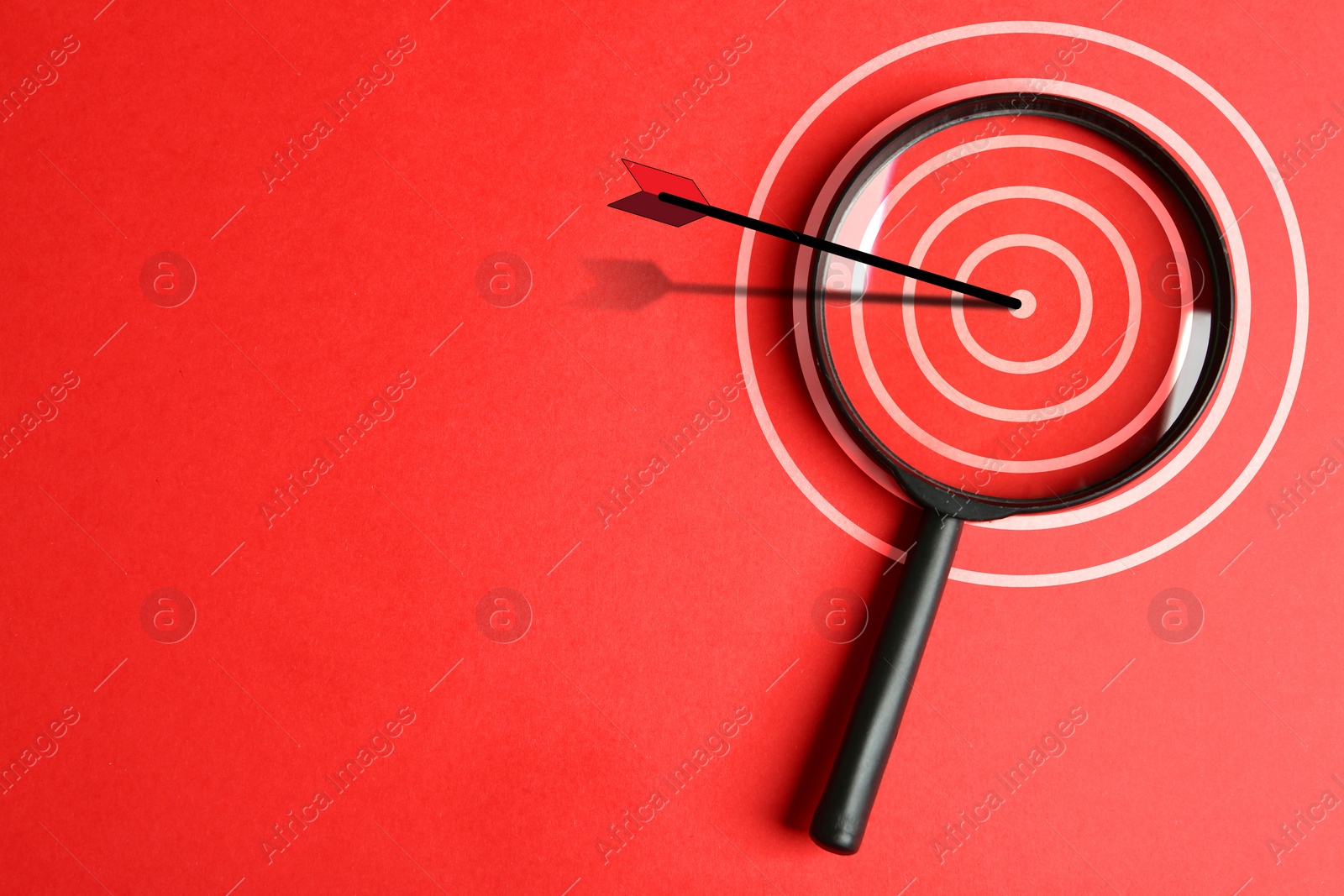 Image of Magnifying glass with illustration of target and arrow on red background, top view. Space for text