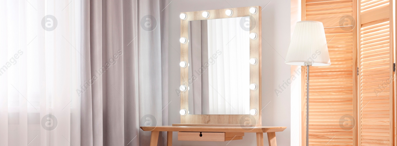 Image of Makeup room. Dressing table with mirror and lamp indoors, space for text. Banner design