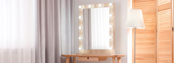 Makeup room. Dressing table with mirror and lamp indoors, space for text. Banner design