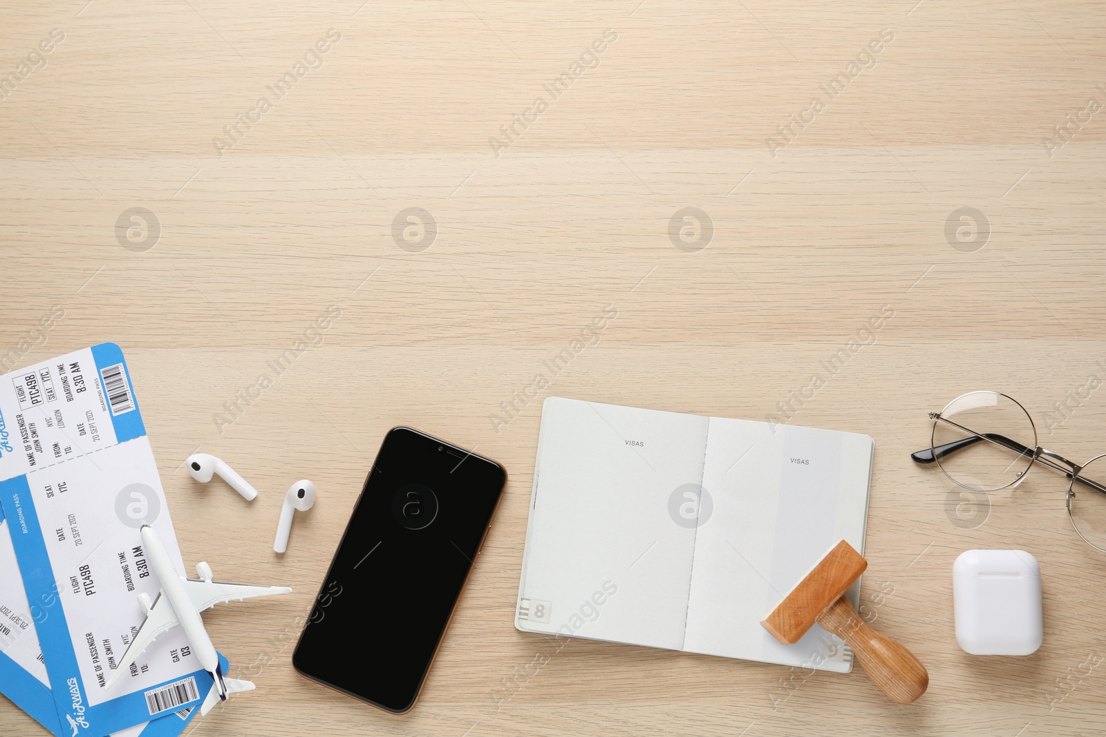 Photo of Flat lay composition with passport, stamp and flight tickets on wooden table, space for text