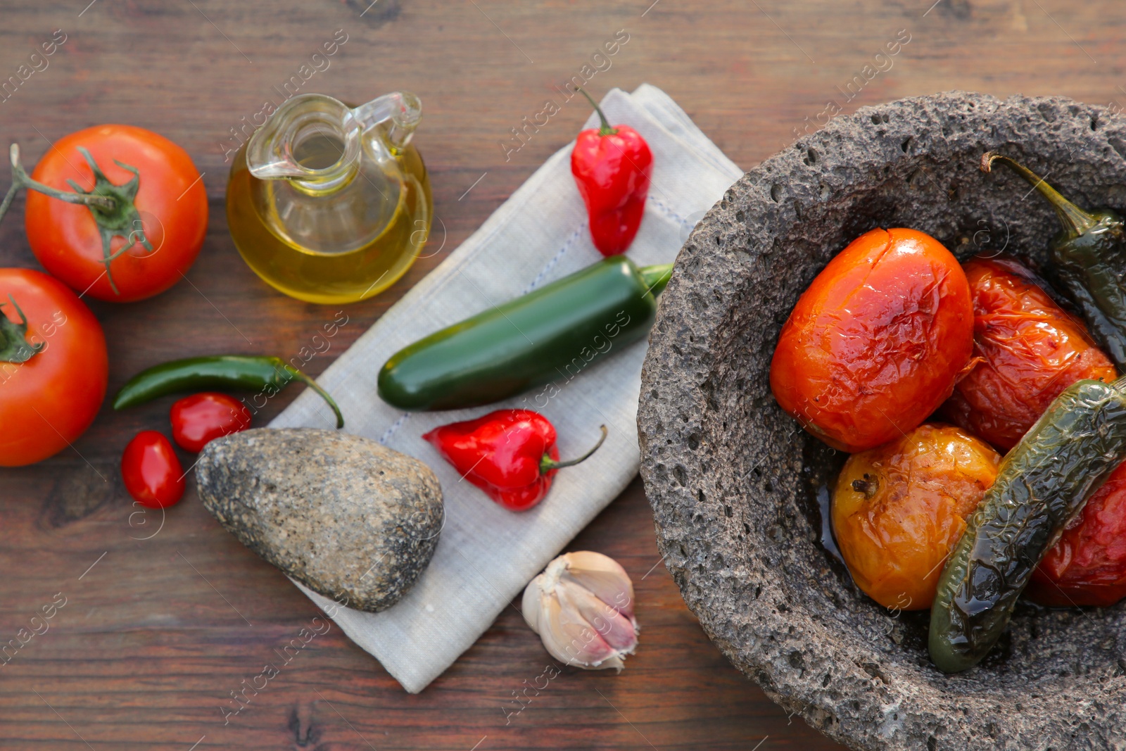 Photo of Ingredients for tasty salsa sauce, pestle and mortar on wooden table, flat lay