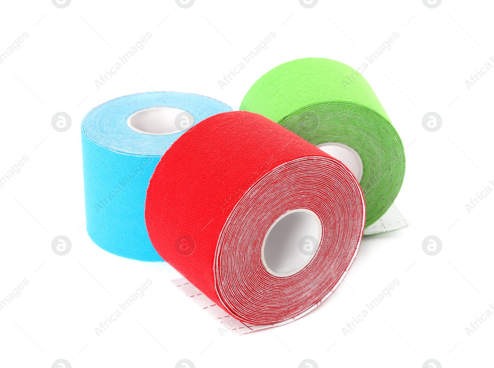 Photo of Many bright kinesio tape in rolls on white background