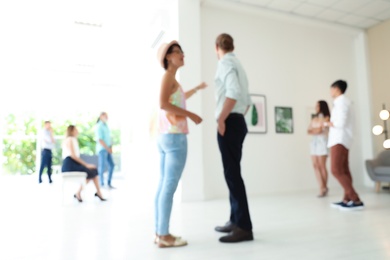 Blurred view of people at exhibition in art gallery