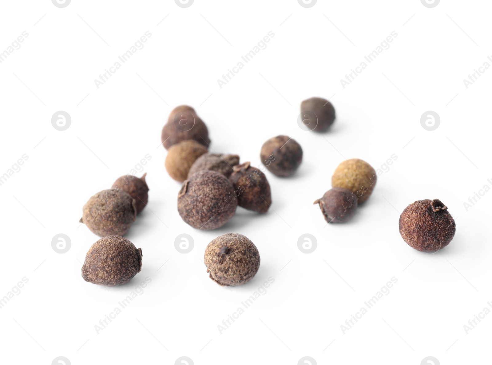 Photo of Spicy black pepper grains isolated on white