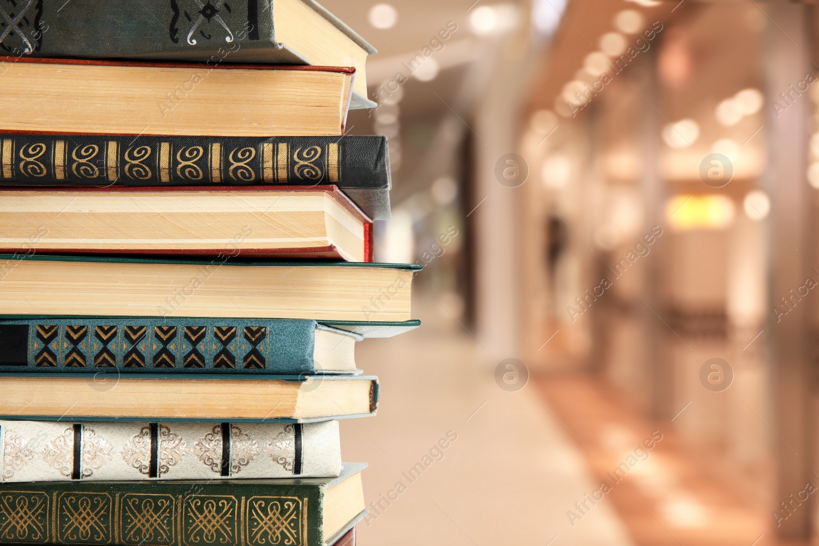 Image of Collection of different books against blurred background, space for text