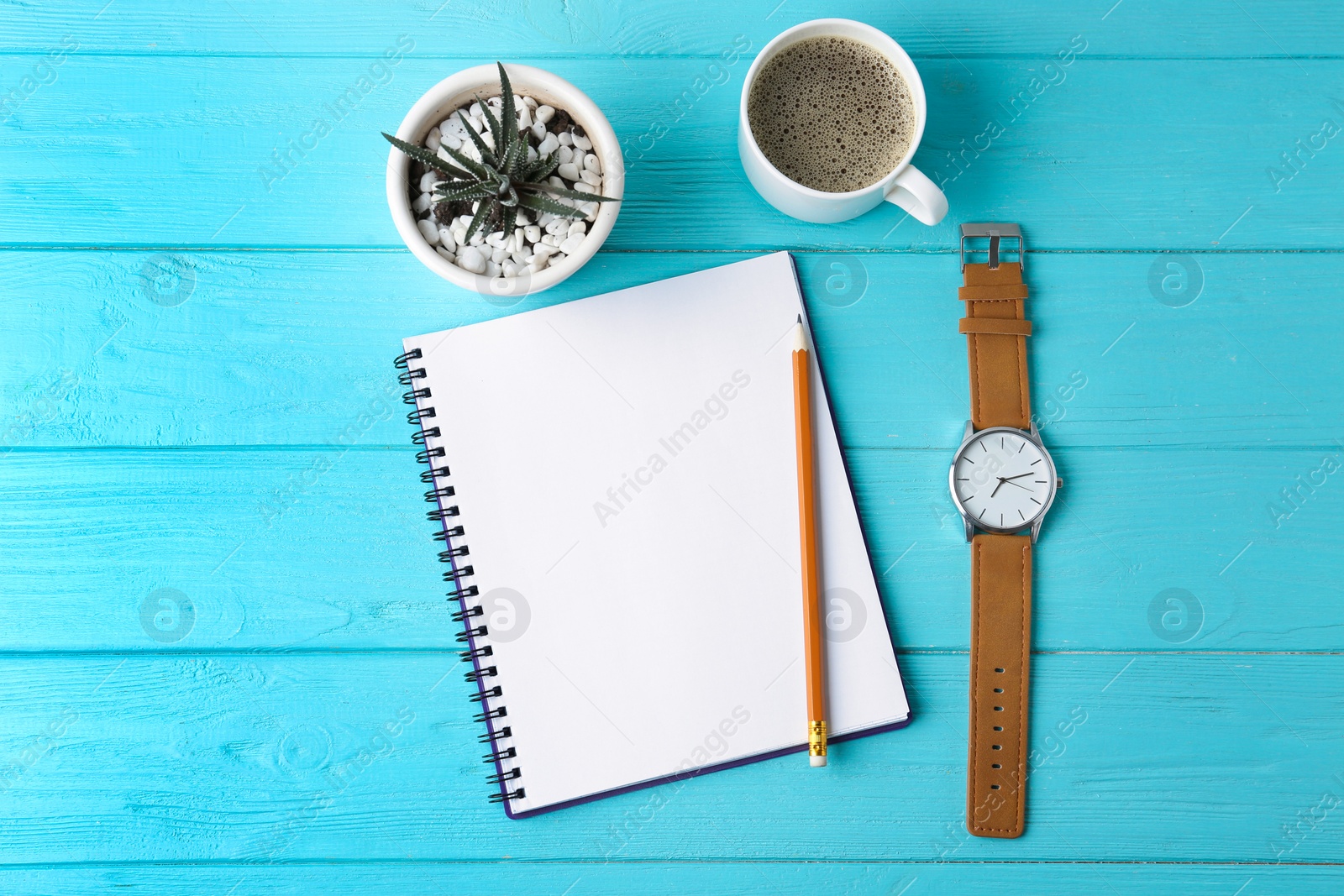 Photo of Flat lay composition with office stationery and cup of coffee on light blue wooden table