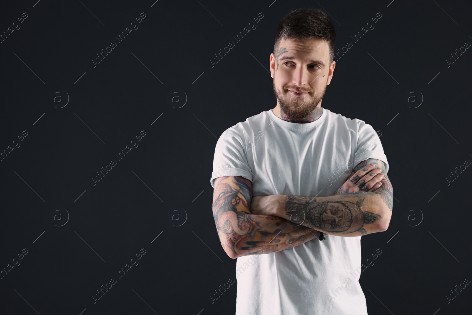 Photo of Handsome hipster man on black background. Space for text