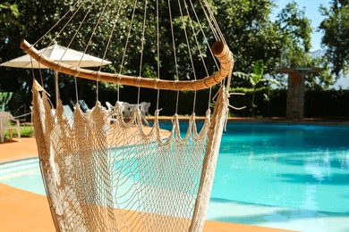 Photo of Hammock near pool with clean water outdoors, closeup
