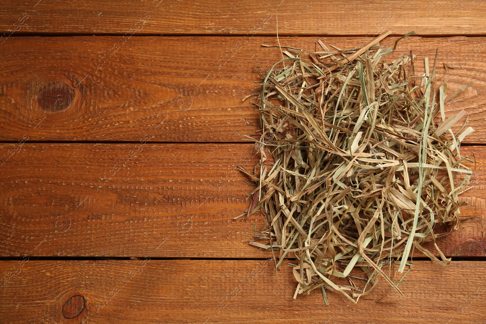 Photo of Dried hay on wooden background, top view. Space for text