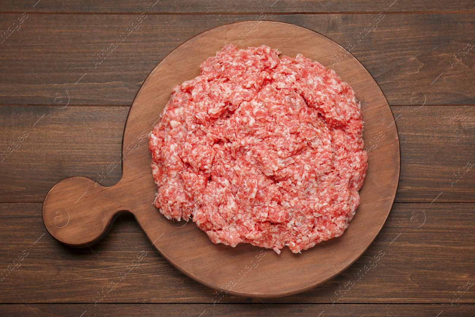 Photo of Raw fresh minced meat on wooden table, top view