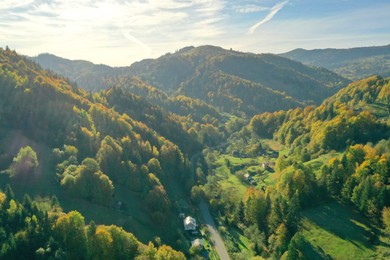 Aerial view of beautiful mountain forest and village on autumn day